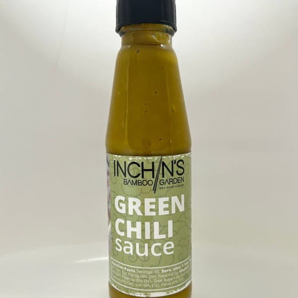 Inchin's Bamboo Garden green chili sauce bottle with a light green label and black cap.