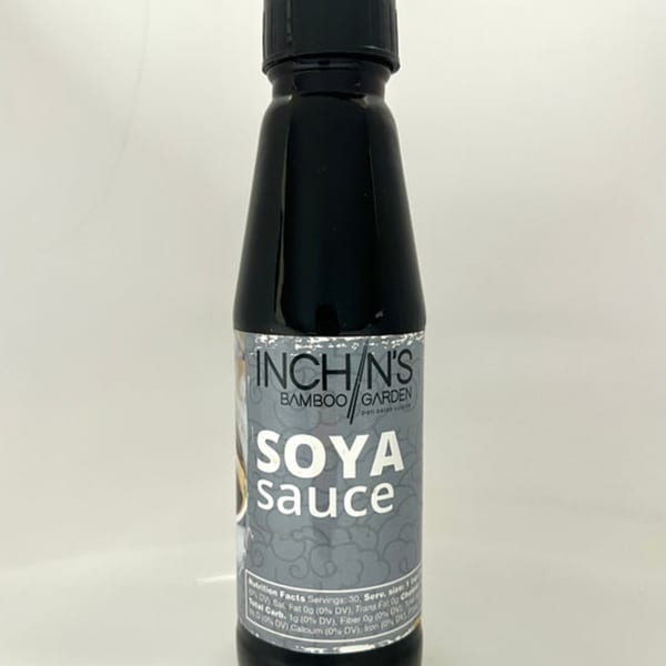 A bottle of Inchin's Bamboo Garden Soya Sauce with a grey and white label.