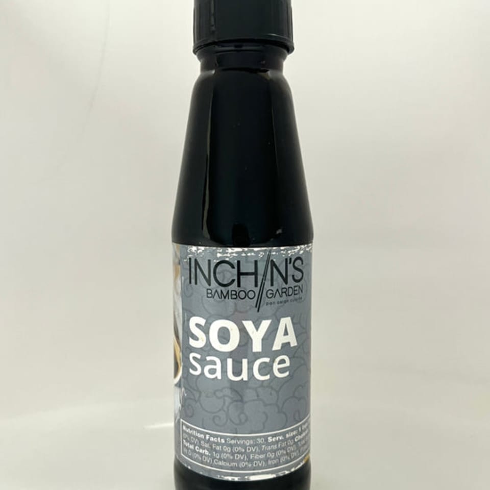 A bottle of Inchin's Bamboo Garden Soya Sauce with a grey and white label.
