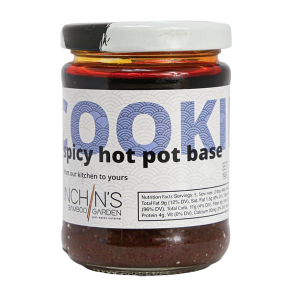 Inchin's Bamboo Garden spicy hot pot base in a glass jar with a white lid.