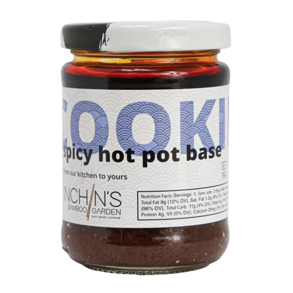 Inchin's Bamboo Garden spicy hot pot base in a glass jar with a white lid.