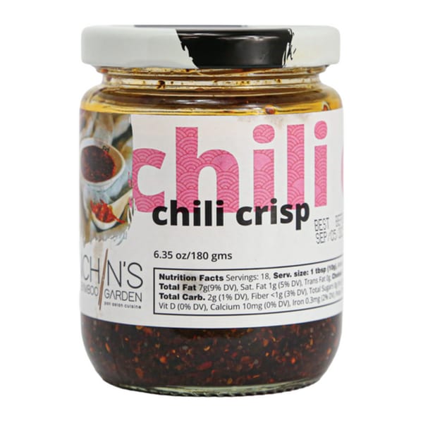 A jar of Inchin's Bamboo Garden chili crisp with a white and pink label.