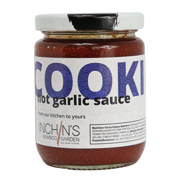 A jar of Inchin's Bamboo Garden Cooki Hot Garlic Sauce with a white label and nutrition facts.