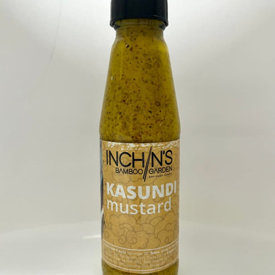 Inchin's Bamboo Garden Kasundi mustard in a clear bottle with a black cap on a white background.