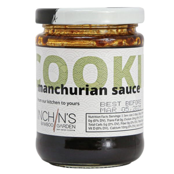 A jar of Inchin's Bamboo Garden Manchurian sauce with a white and black lid.