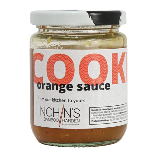 A jar of Inchin's Bamboo Garden orange sauce with a white and black lid.