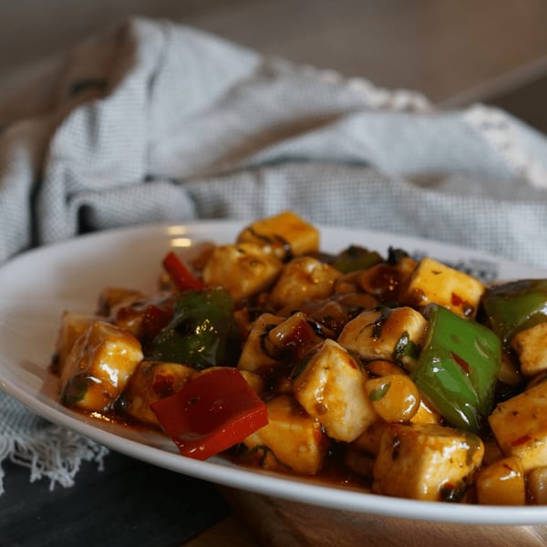 Inchin's Bamboo Garden's chili paneer with bell peppers and onions in a rich sauce.
