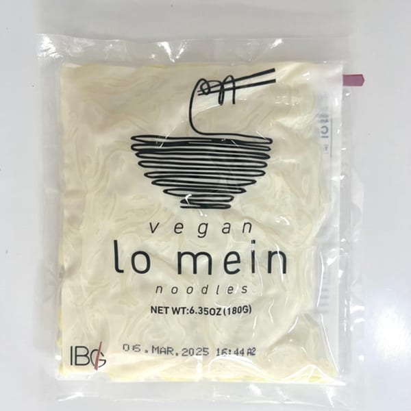 A clear plastic package of Inchin's Bamboo Garden vegan lo mein noodles with a bowl and chopsticks logo.