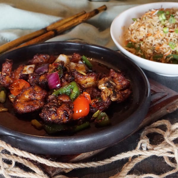 Inchin's Bamboo Garden's chili chicken with bell peppers and onions, served with fried rice.
